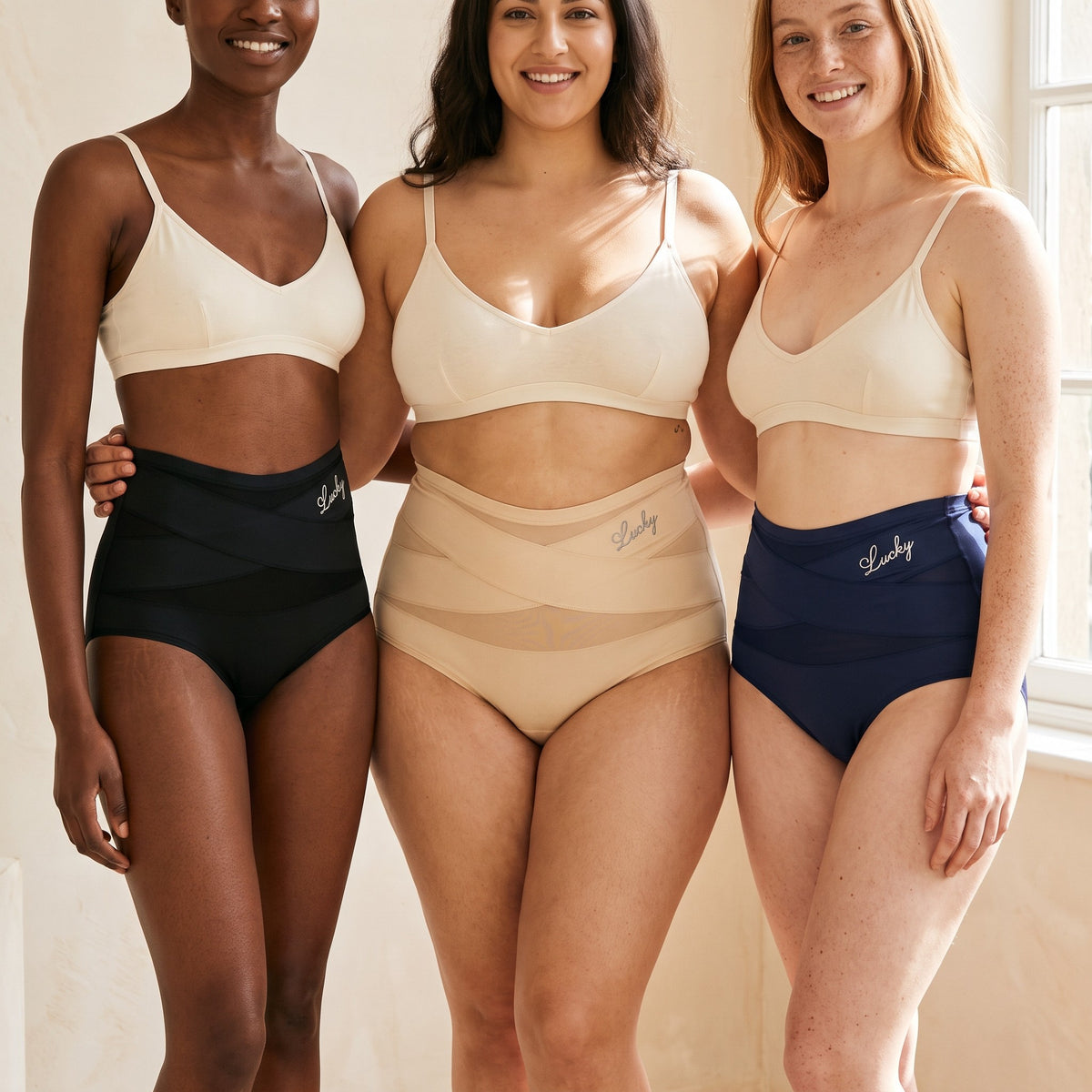 Three women wearing the shaping briefs