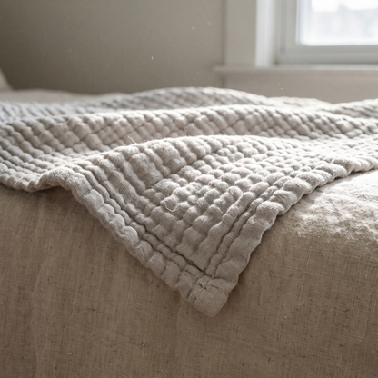 Detail of the finished edge and stitched grid of the gauze blanket