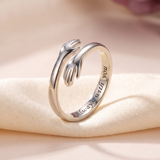 Silver hug ring with two little hands, engraved inside: Always with you