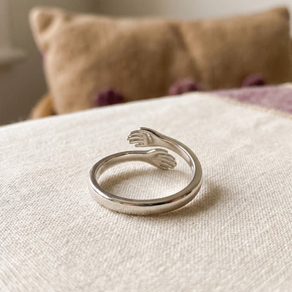 Hug ring resting on cream linen
