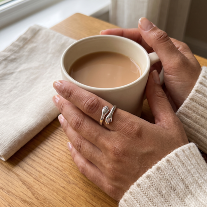 Hug ring on a hand holding a mug of tea