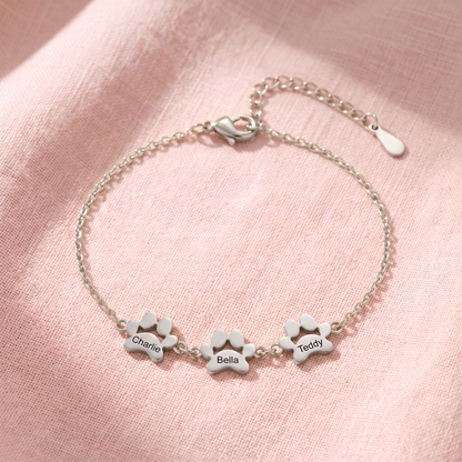Silver paw print name bracelet with three engraved paws