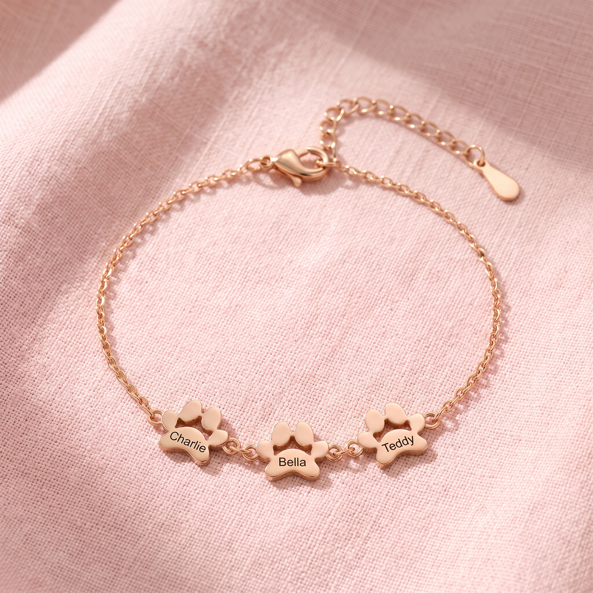 Rose gold paw print name bracelet with three engraved paws